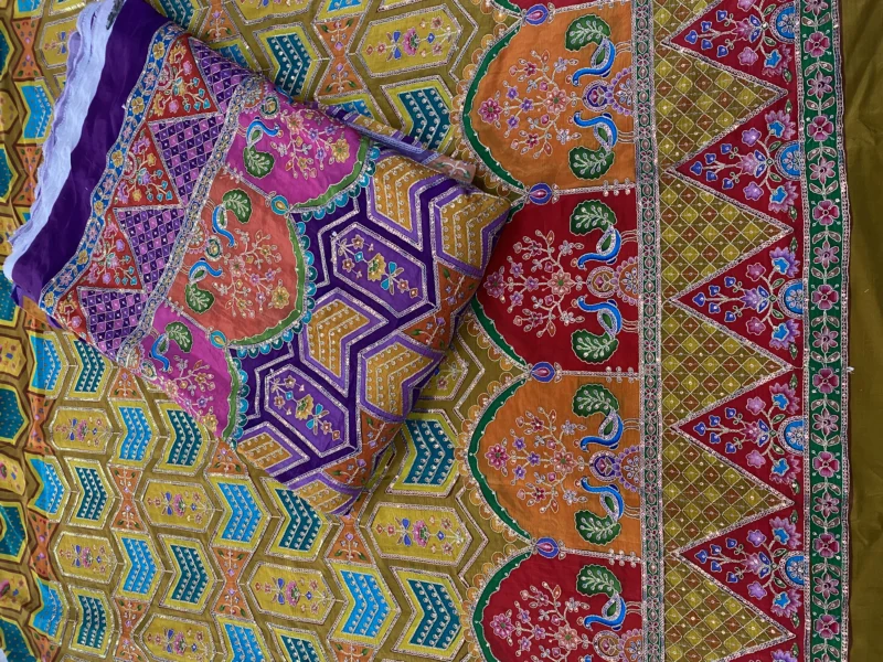 Position placement embroidery on printed fabric for luxury outfits