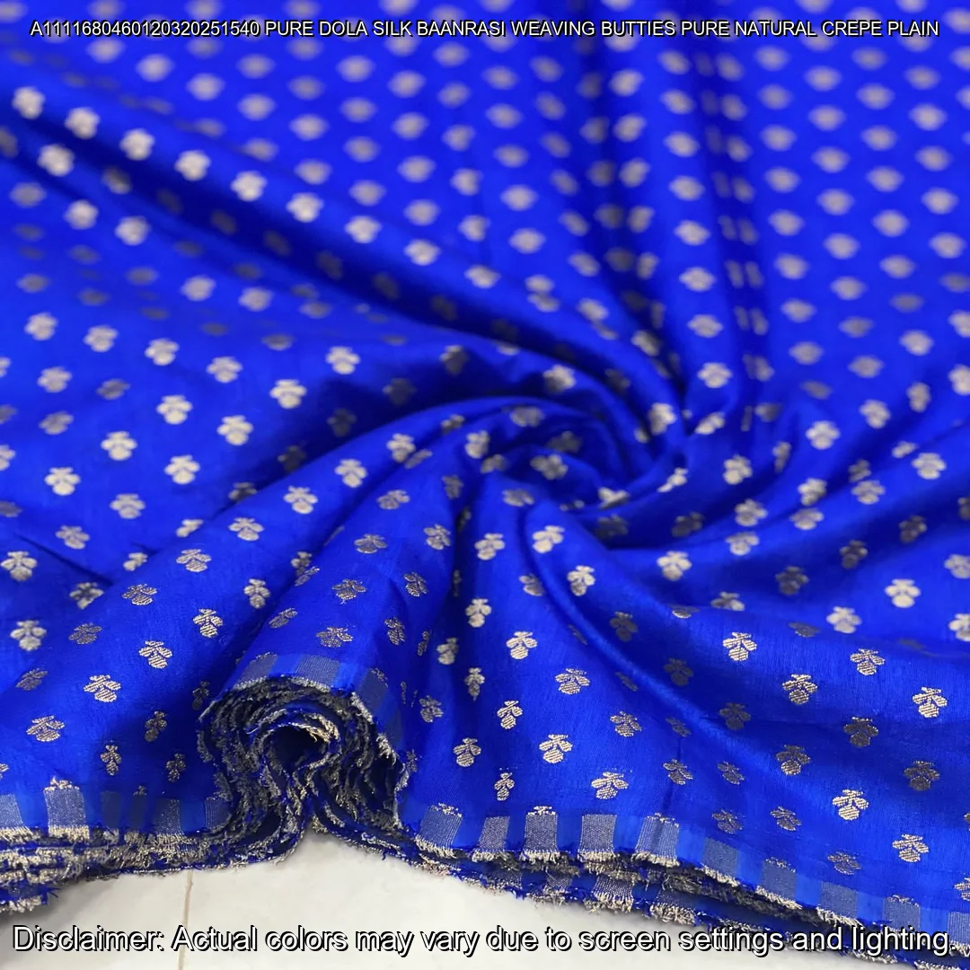 Soft & luxurious Pure Dola Silk Banarasi Fabric with elegant buttie weaving. Perfect for sarees & lehengas. Shop now at ₹440/M!