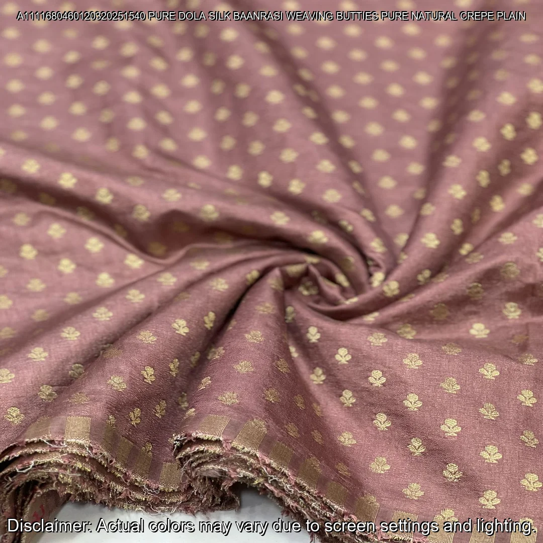 Soft & luxurious Pure Dola Silk Banarasi Fabric with elegant buttie weaving. Perfect for sarees & lehengas. Shop now at ₹440/M!
