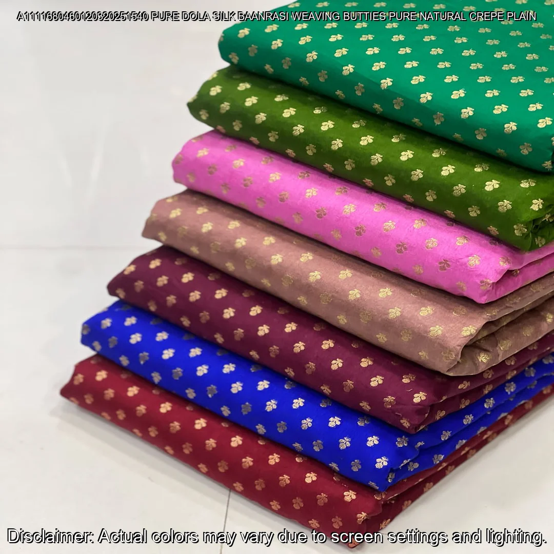 Soft & luxurious Pure Dola Silk Banarasi Fabric with elegant buttie weaving. Perfect for sarees & lehengas. Shop now at ₹440/M!