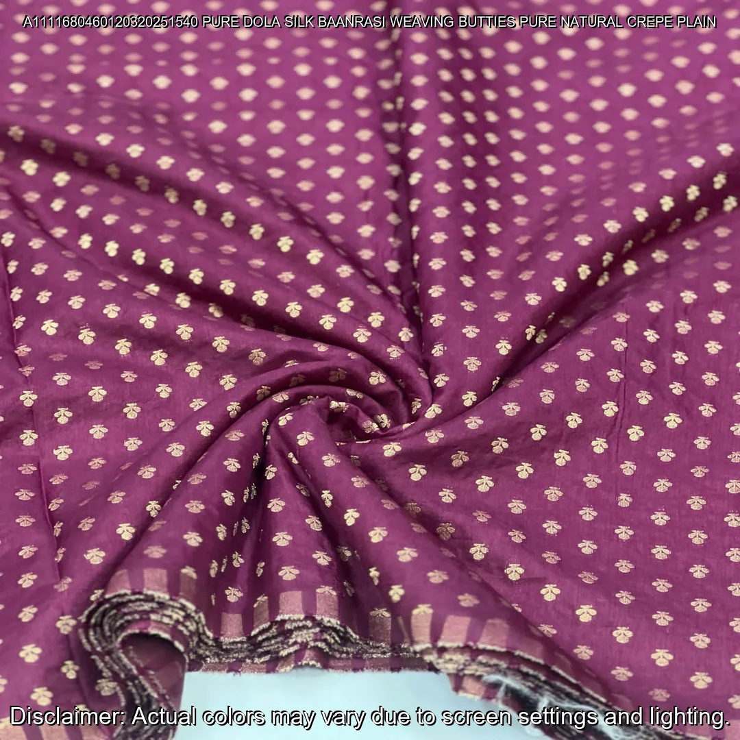 Soft & luxurious Pure Dola Silk Banarasi Fabric with elegant buttie weaving. Perfect for sarees & lehengas. Shop now at ₹440/M!