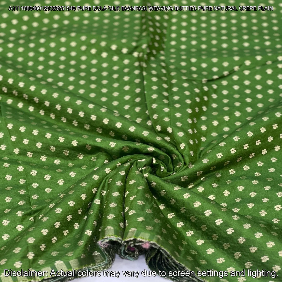 Soft & luxurious Pure Dola Silk Banarasi Fabric with elegant buttie weaving. Perfect for sarees & lehengas. Shop now at ₹440/M!