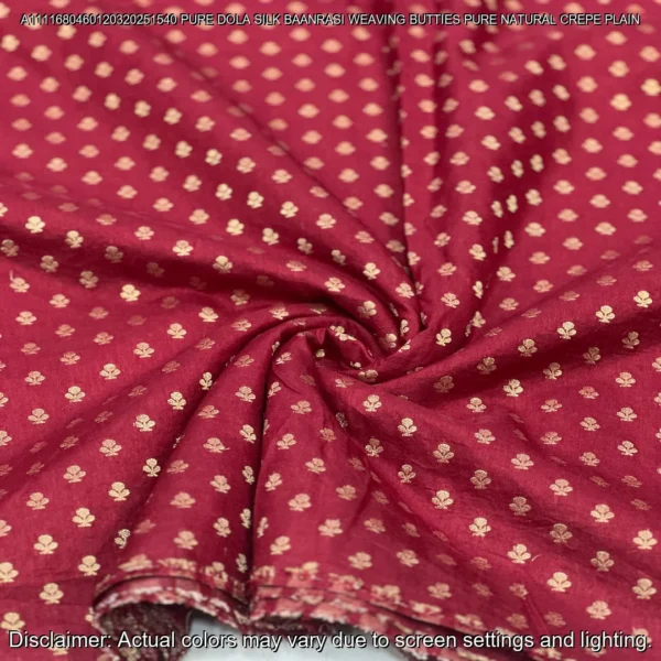 Soft & luxurious Pure Dola Silk Banarasi Fabric with elegant buttie weaving. Perfect for sarees & lehengas. Shop now at ₹440/M!