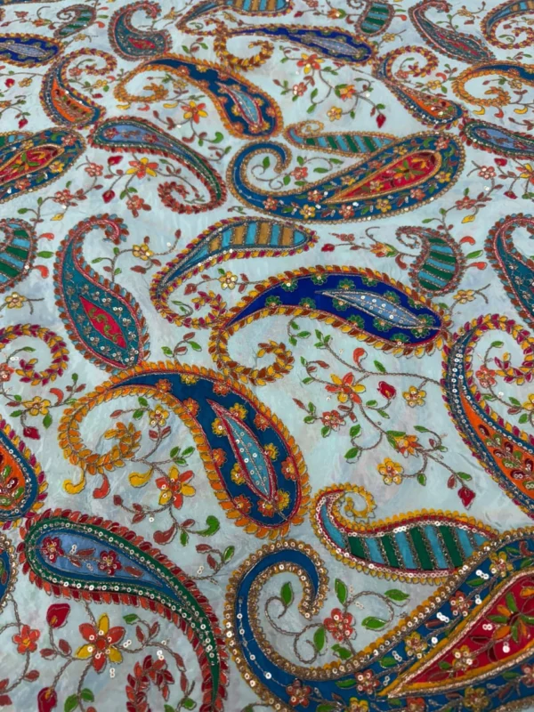 Close up of sequence embroidery on natural crepe